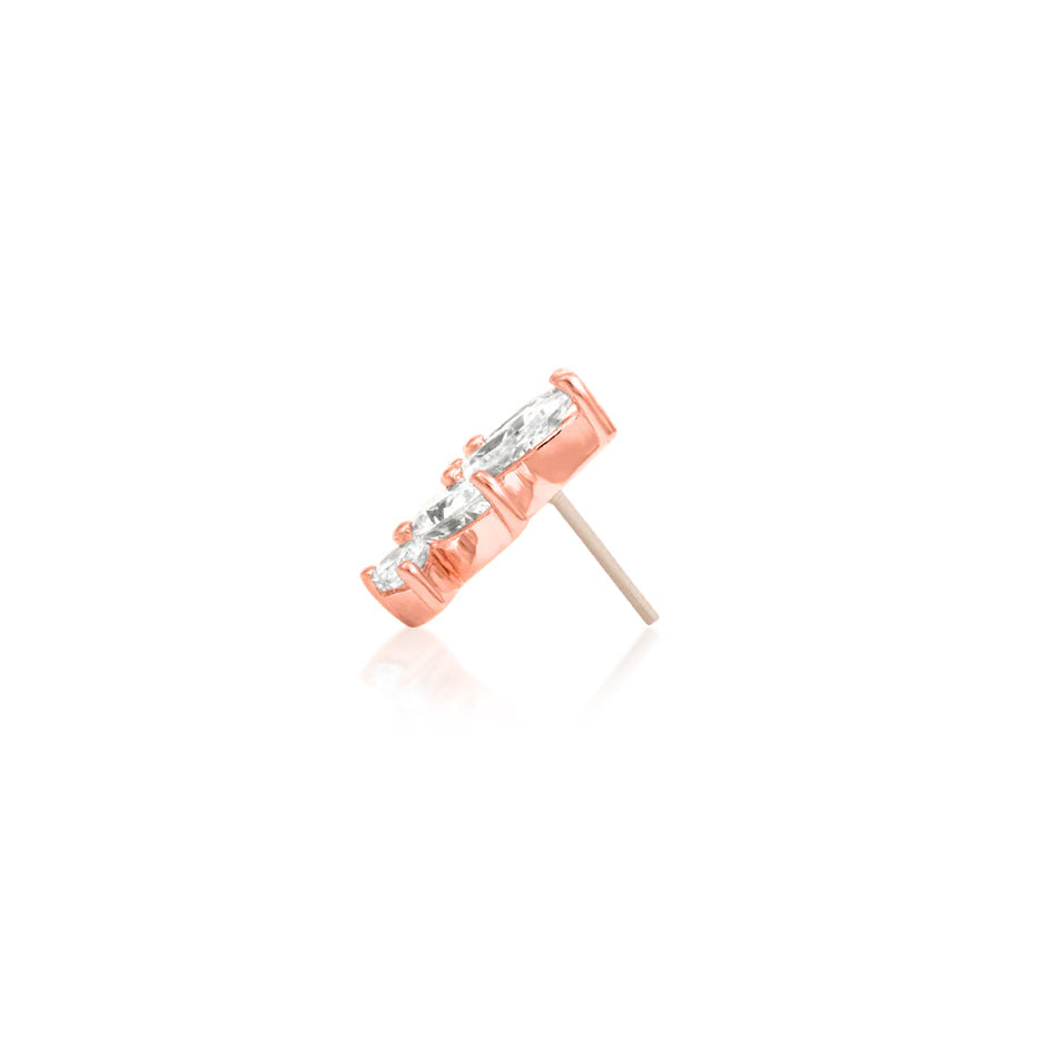 Rose gold earring with clear gemstone on a white background