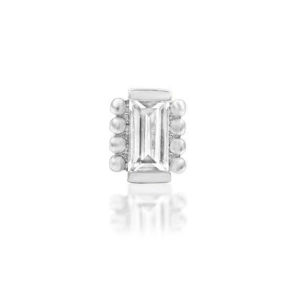     Close-up of the 4mm × 2mm baguette-cut white CZ in Junipurr René