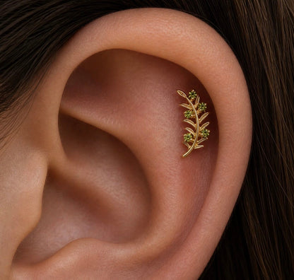 Junipurr Olive Branch green CZ jewellery worn in an upper-ear piercing to show its scale.