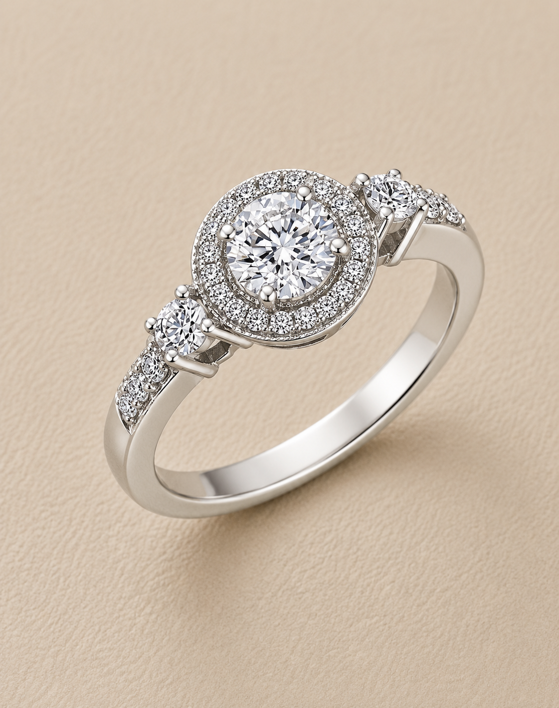BVLA bespoke white gold engagement ring featuring a round brilliant diamond with a diamond halo, diamond shoulders and handcrafted luxury custom design.