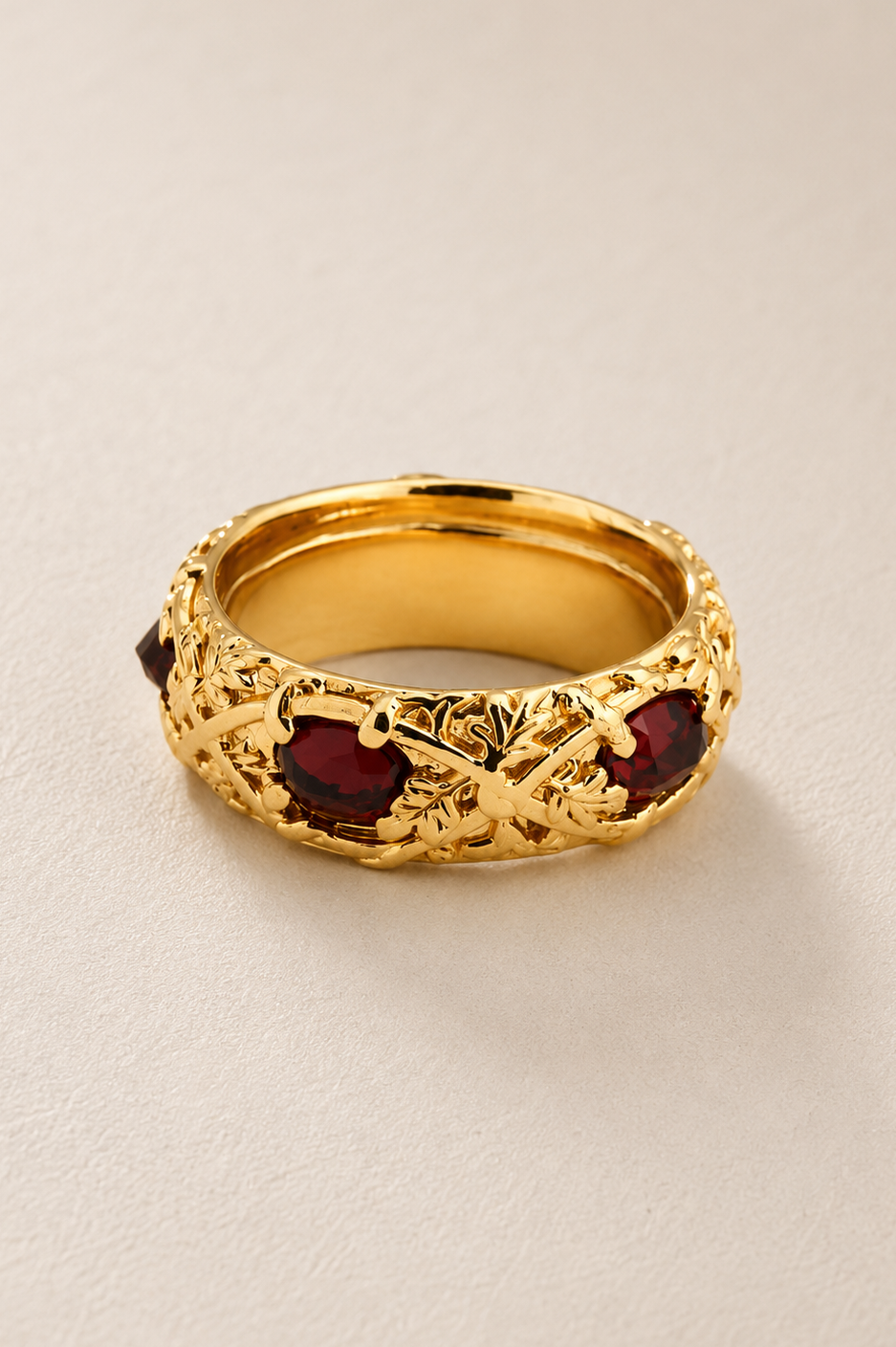 BVLA bespoke yellow gold ring featuring deep red garnets in an engraved vintage-inspired band, handcrafted as a luxury custom statement ring.