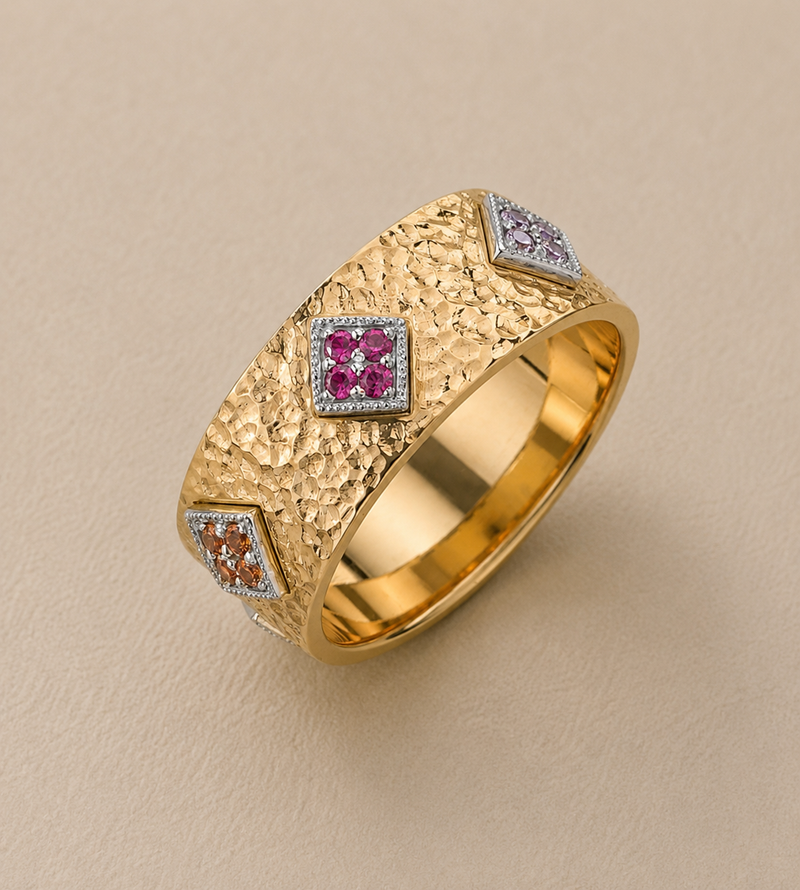 BVLA bespoke yellow gold statement ring featuring a textured handcrafted band with pink, lilac and orange gemstone clusters, created as a luxury custom ring.