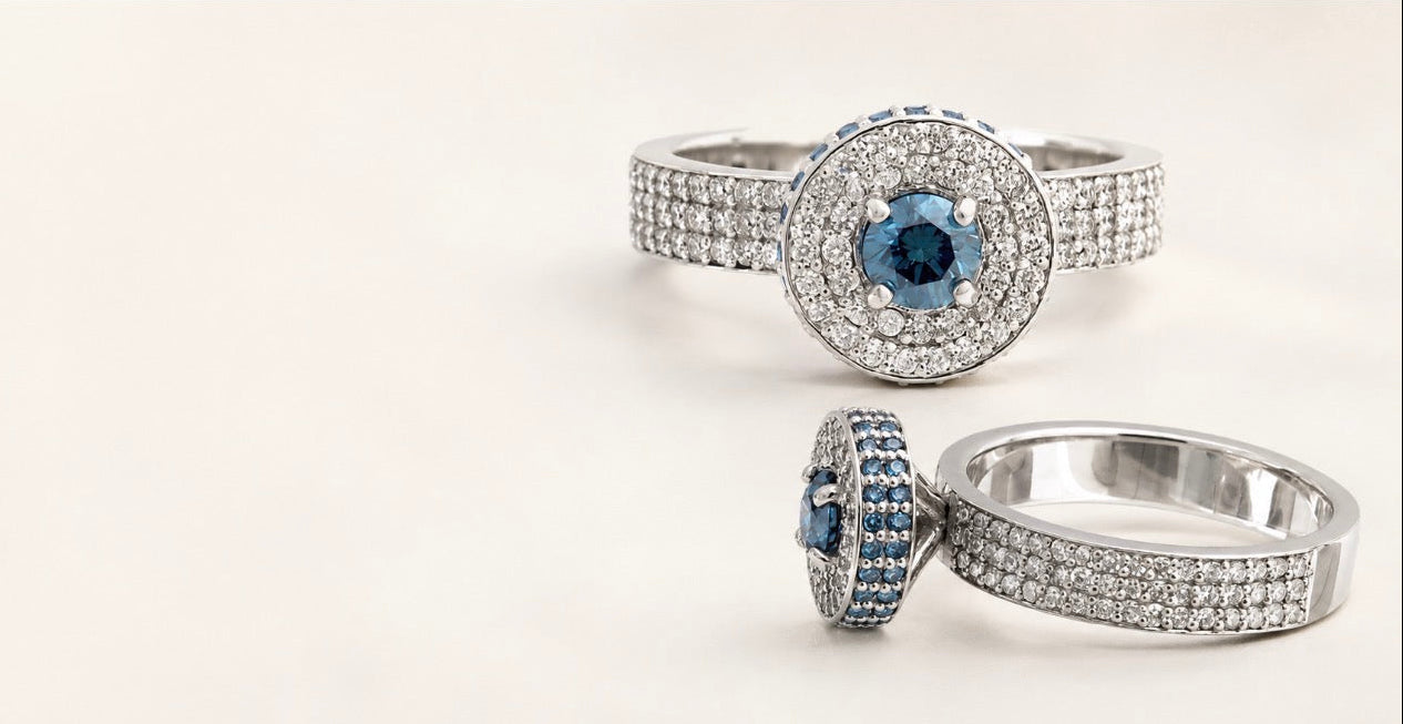 BVLA bespoke white gold ring featuring a round ocean blue diamond centre with a white diamond halo, blue diamond accents and pavé diamond band in a handcrafted luxury custom engagement ring.