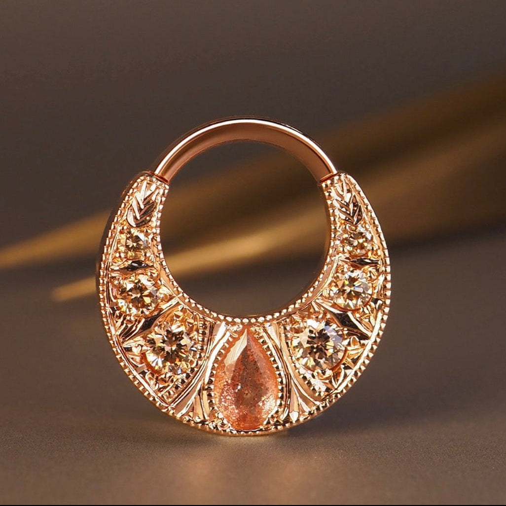 BVLA Boston rose gold septum ring featuring a pear-cut Oregon sunstone with champagne diamonds in an ornate handcrafted luxury body jewellery design.