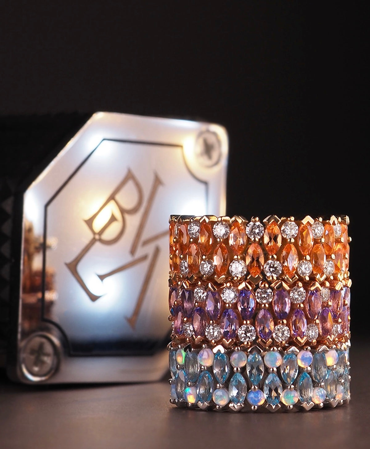 Three BVLA narrow 3 x 2 row 14k gold clicker rings featuring Chatham champagne sapphires with diamonds, tanzanites with diamonds, and Swiss blue topaz with white opals, displayed as luxury gemstone body jewellery.