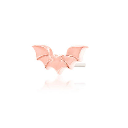 Angled view of Junipurr Bruce solid 14k rose gold bat threadless decorative end with gothic styling