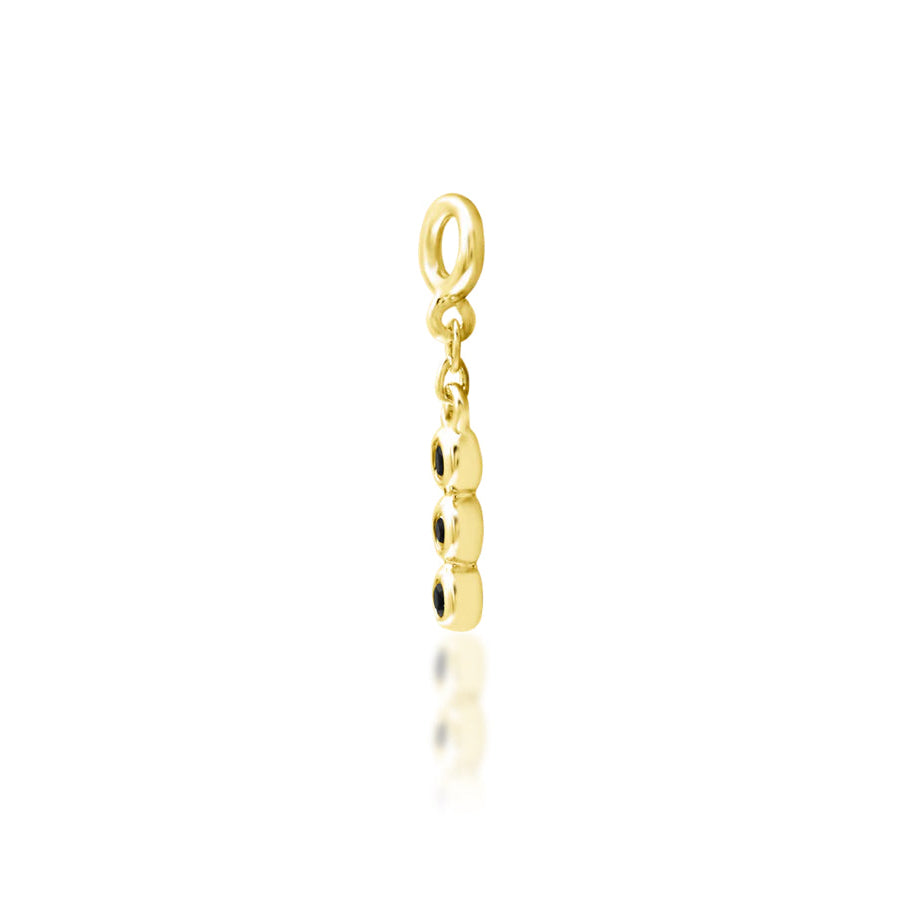 Angled view of Junipurr Cohen black CZ charm in yellow gold for conch jewellery
