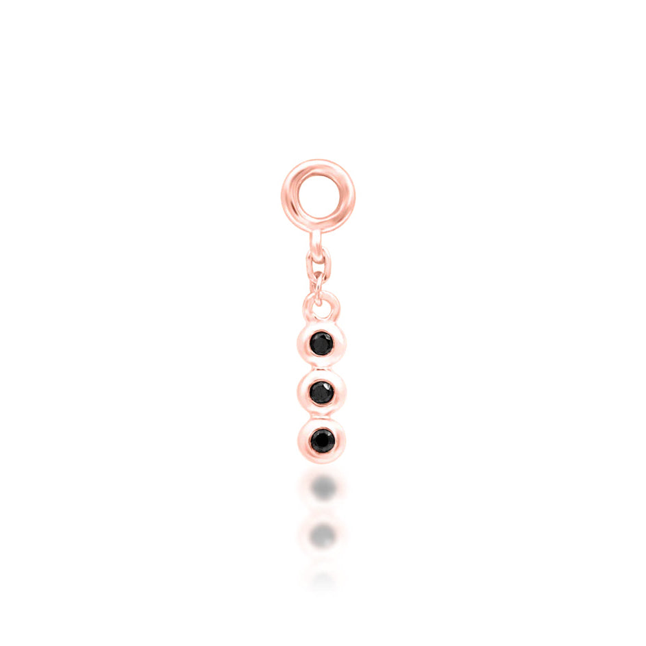 Side profile of Junipurr Cohen charm in white gold with black cubic zirconia
