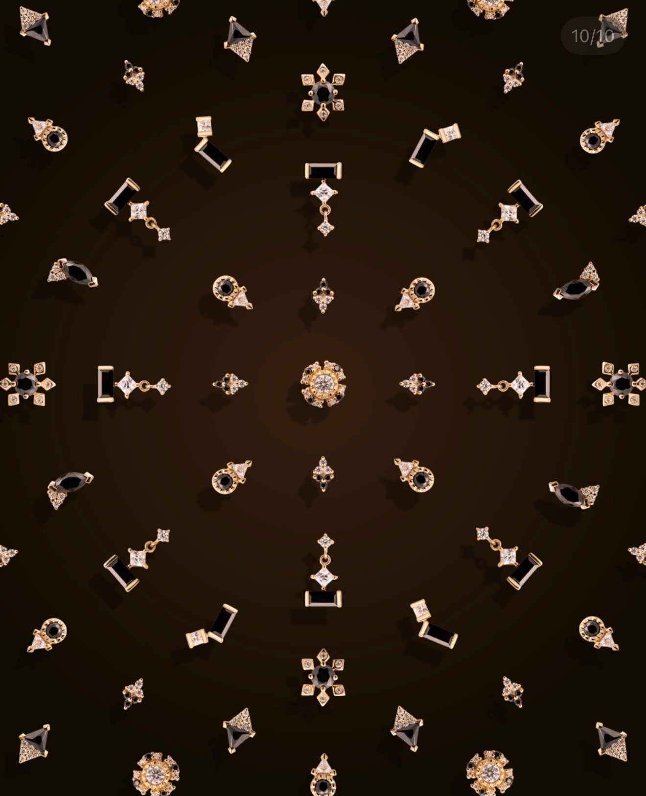 Junipurr Contrast Collection of black and white CZ solid gold piercing jewellery arranged on a deep espresso background