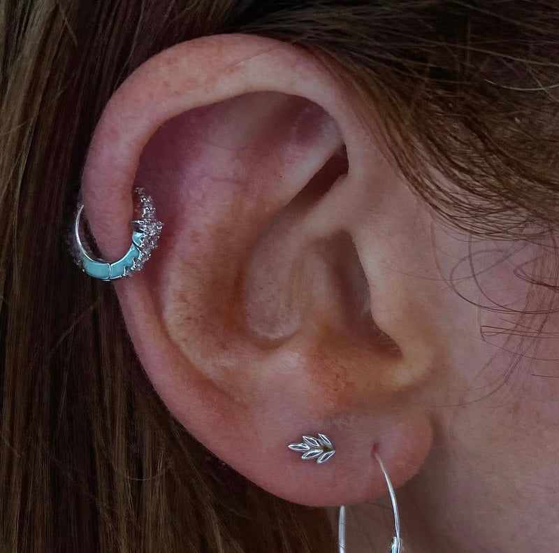 Curated ear styling featuring a Junipurr Fernanda leaf end in solid 14k white gold paired with a white gold helix ring adorned with opal and cubic zirconia detailing.