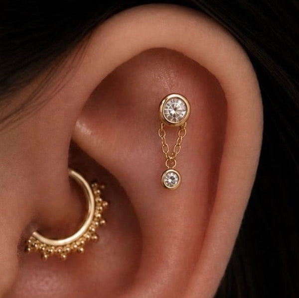 Junipurr Halo solid 14k gold tri bead clicker ring worn in a daith piercing.