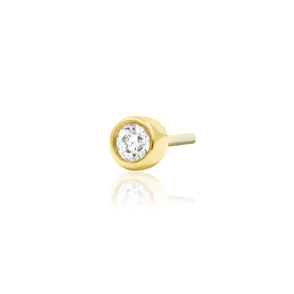 Angled view of Junipurr Jewellery bezel set cubic zirconia threadless decorative end in yellow gold