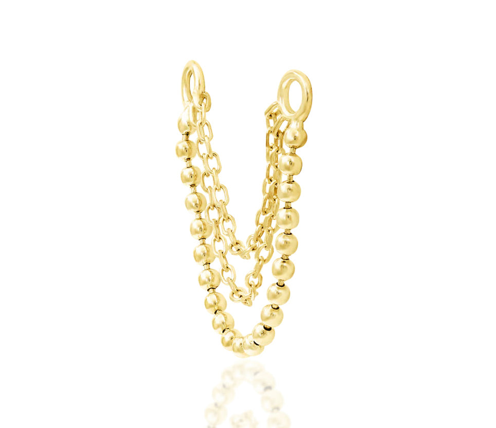 Off front angled view of the Junipurr Jewellery Quinn charm in yellow gold highlighting layered chain movement.