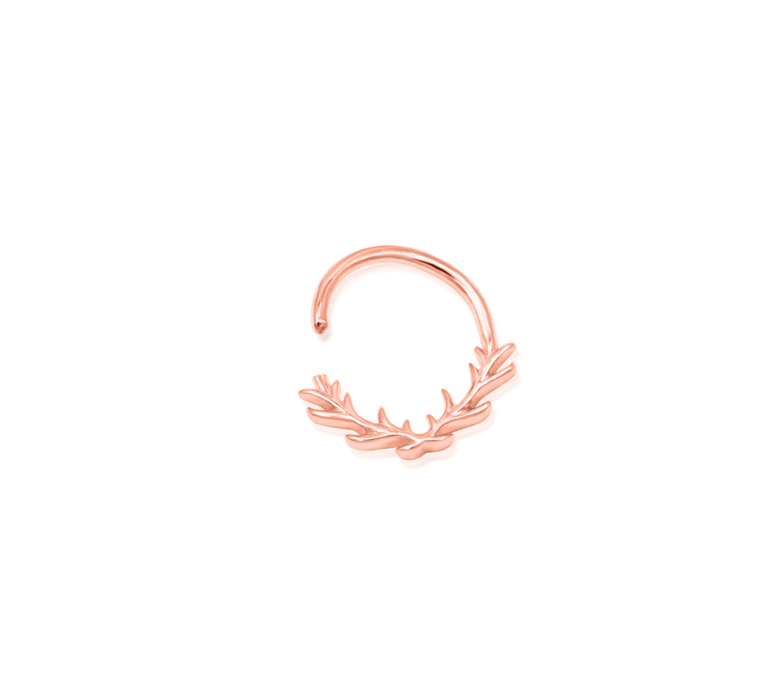 Off-front angled view of the Junipurr Jewellery Raven ring in rose gold, showcasing its warm polished tone