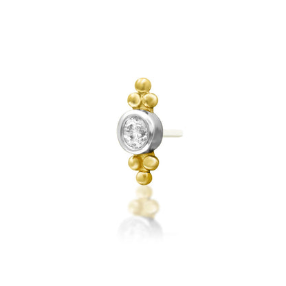 Angled view of Junipurr Jewellery Wit yellow gold threadless decorative end showing refined white CZ detail