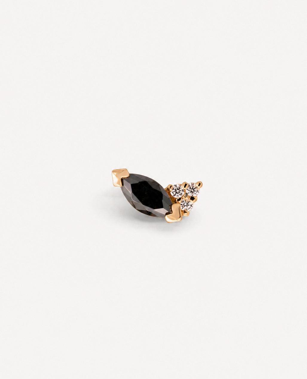 Junipurr Kesia yellow gold piercing jewellery with a black marquise CZ and a cluster of three white CZ stones