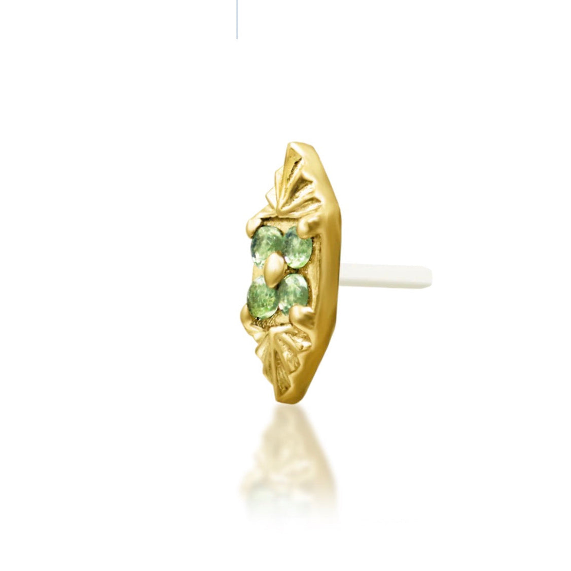 Angled view of a yellow gold decorative end with green and white cubic zirconia.