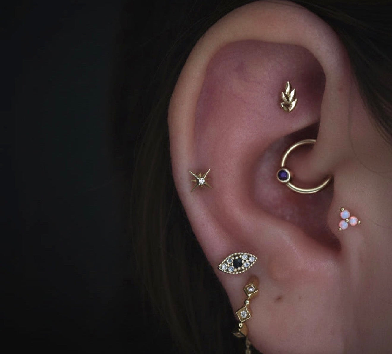 Rose gold star with central white cz gemstone.