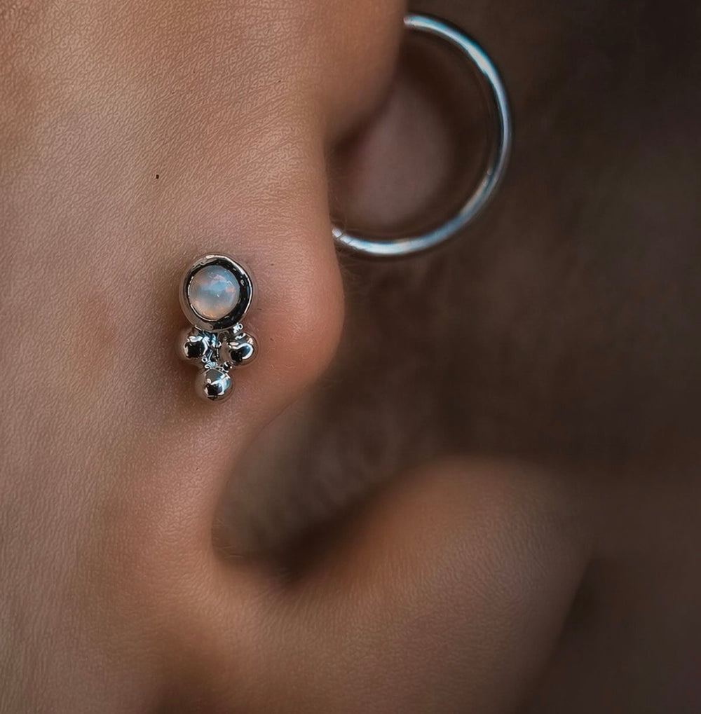 Close-up of Tragus piercing with delicate 14k gold jewellery