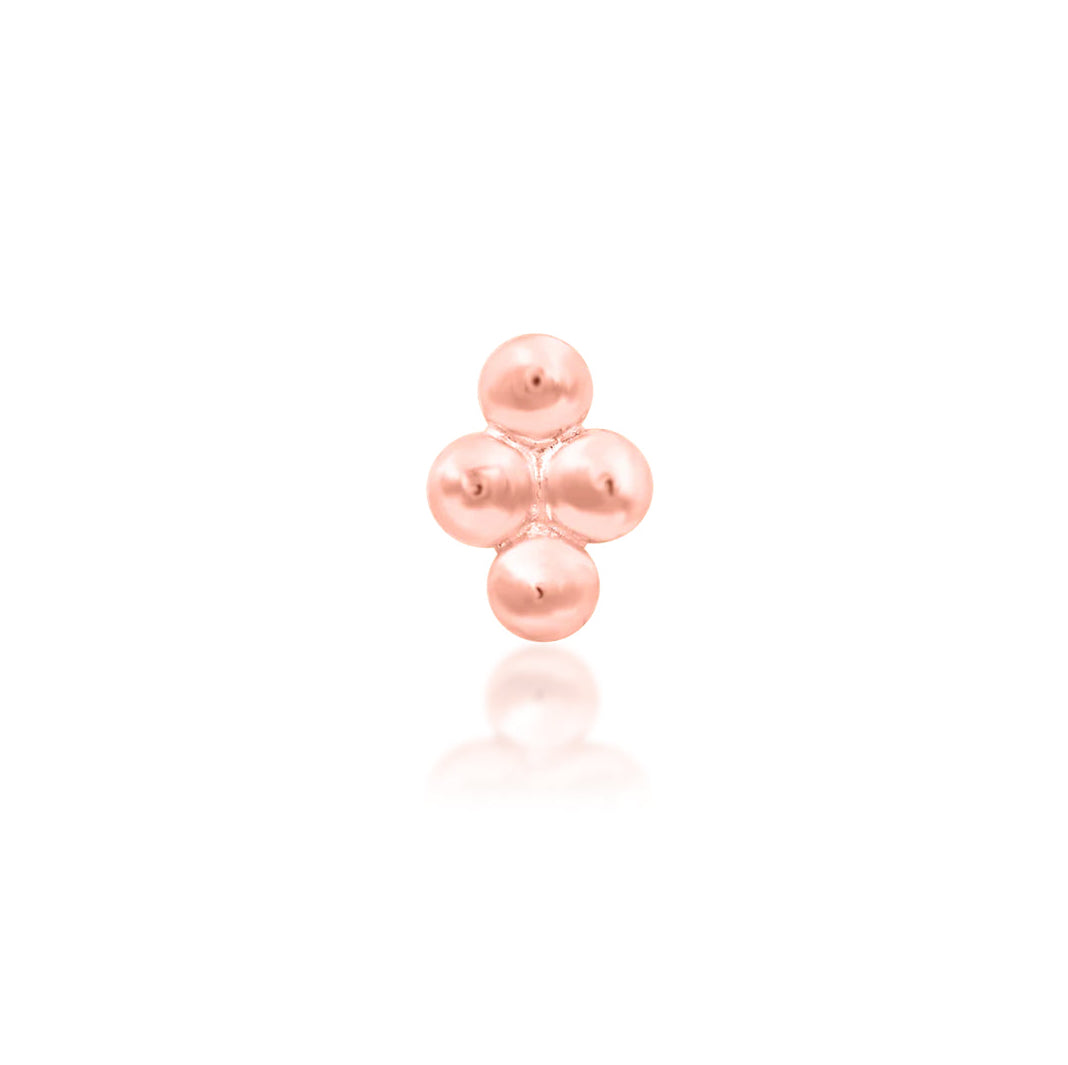 Beaded gold nose stud end in solid rose gold, with a compact diamond-shaped grouping of polished beads.
