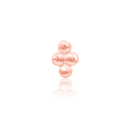 Beaded gold nose stud end in solid rose gold, with a compact diamond-shaped grouping of polished beads.