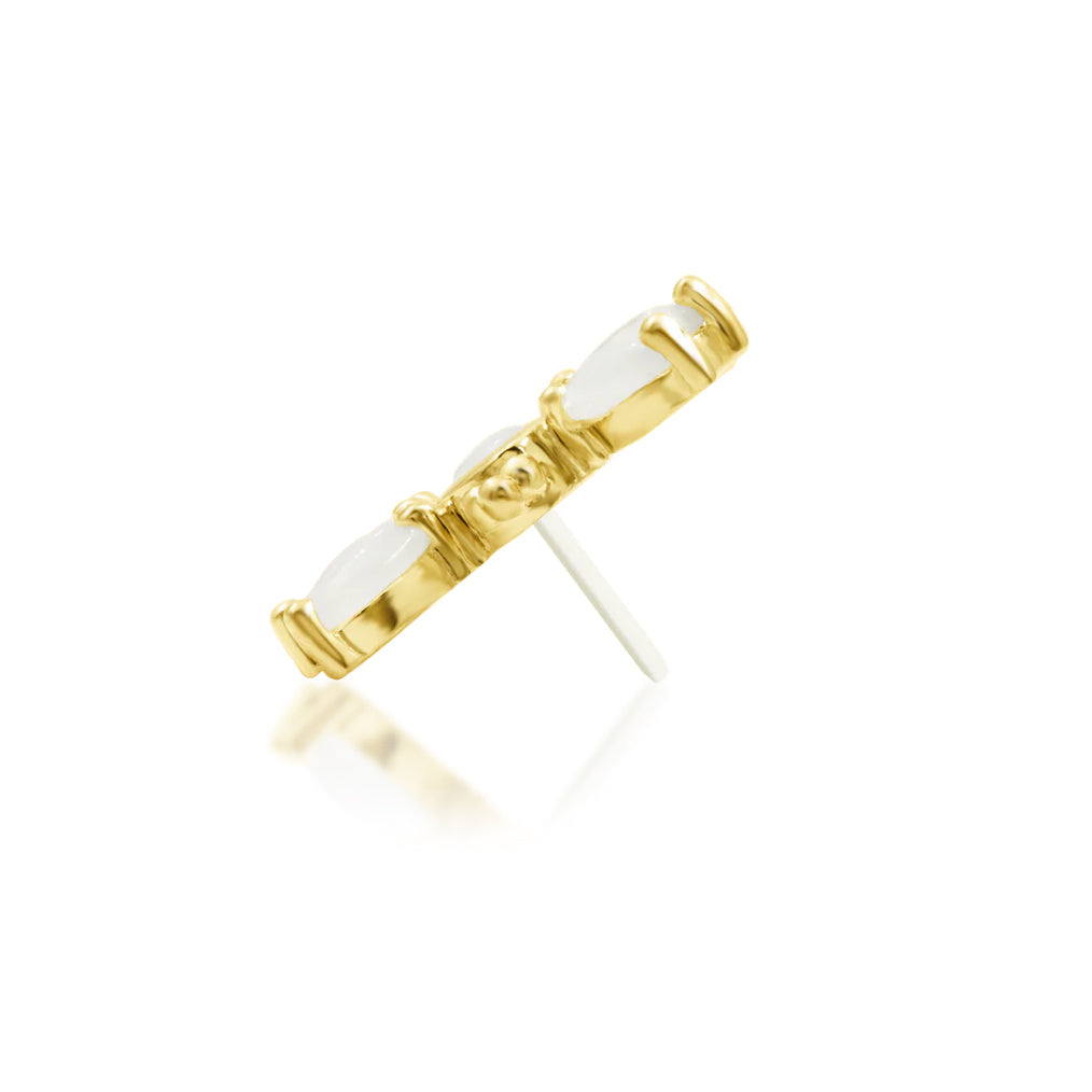 Side profile of Junipurr Bette showing its raised yellow gold moonstone settings
