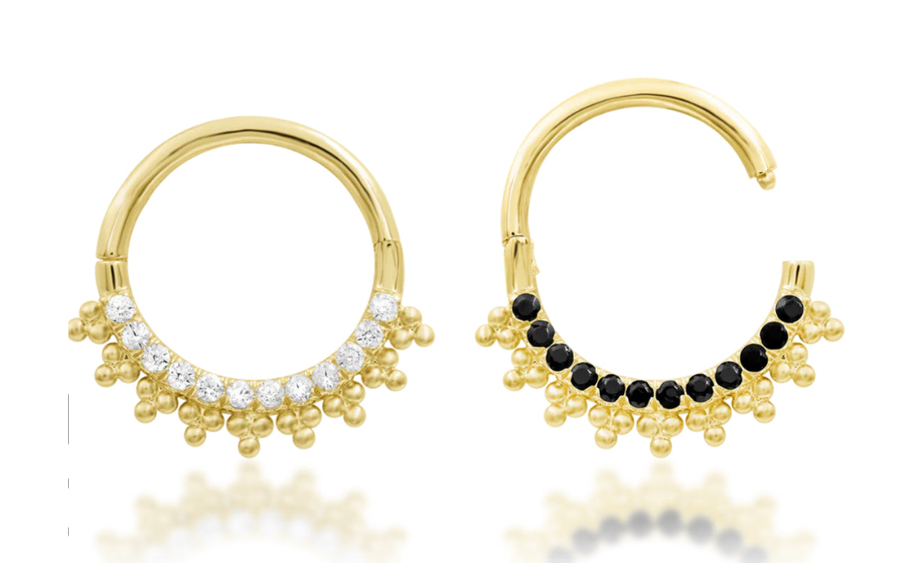 Black CZ daith ring in yellow gold, showing the dark gemstone side and decorative gold beadwork of Double Agent.