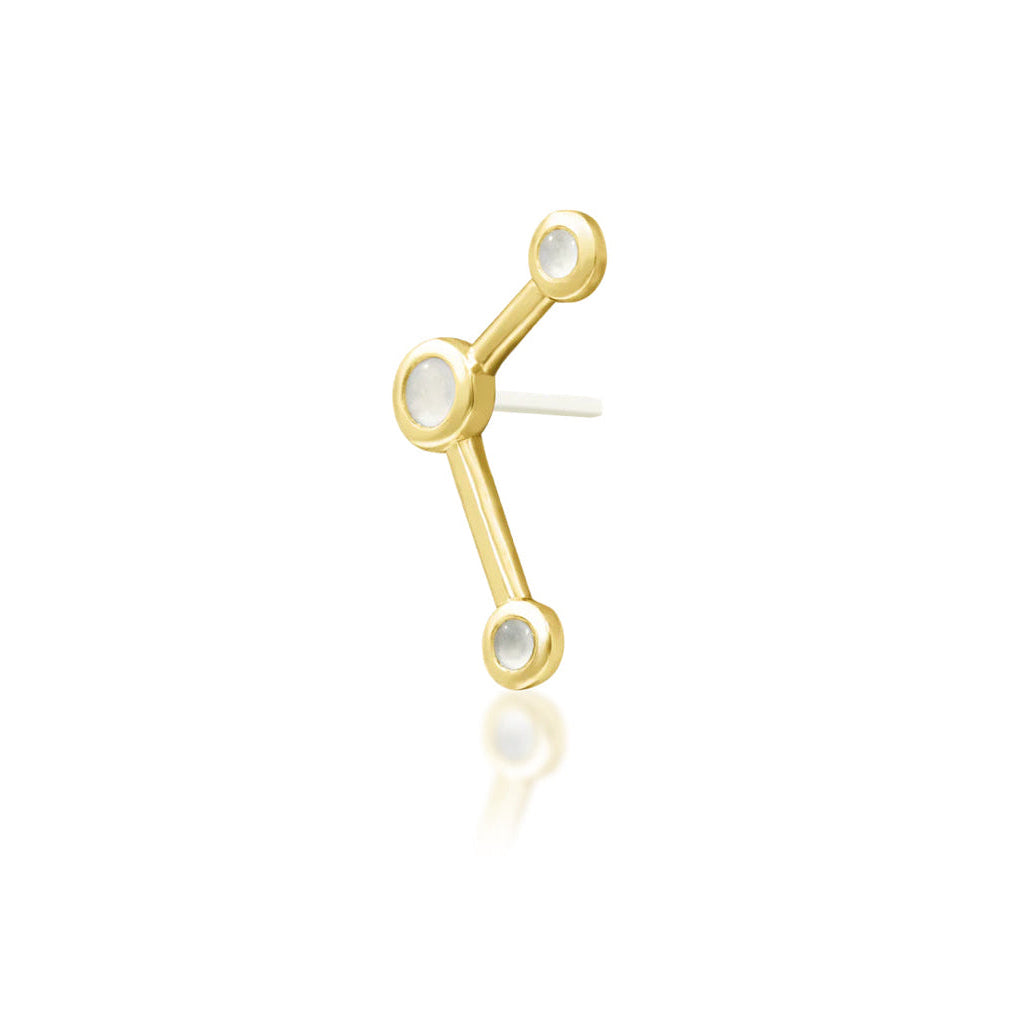 Angled view of yellow gold Junipurr Asteria showing its elongated three-moonstone design