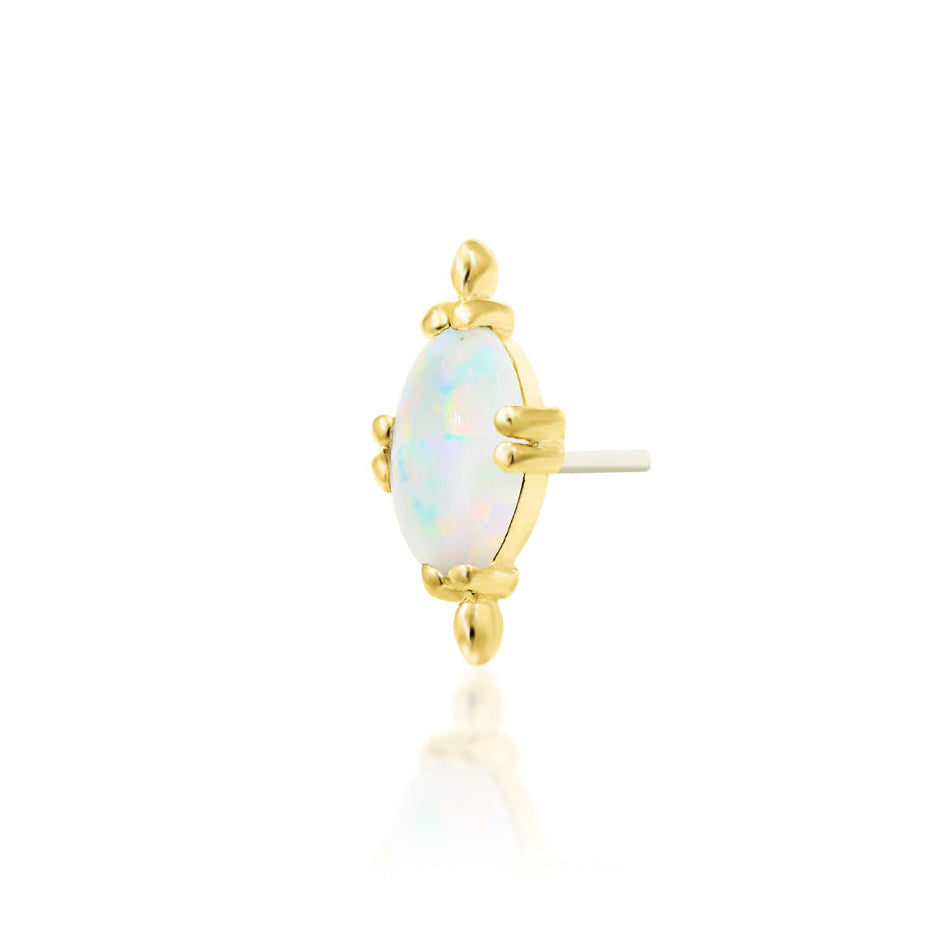 Yellow gold conch earring with an oval white faux opal cabochon and polished bead detailing