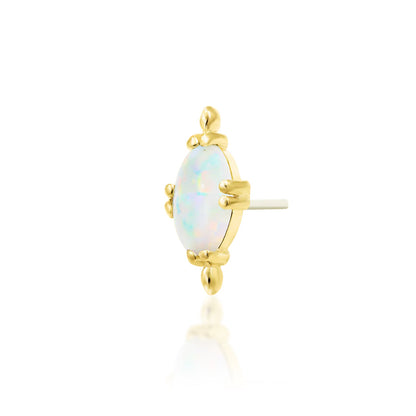 Yellow gold conch earring with an oval white faux opal cabochon and polished bead detailing