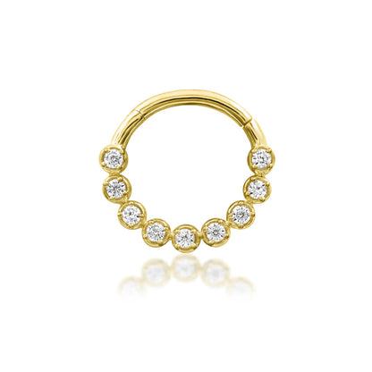 Gold daith clicker in 14k yellow gold with graduated white CZ stones across the front of Junipurr Aziza.