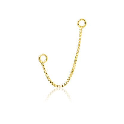     Junipurr Box Chain styled as a solid 14k yellow gold chain for paired nostril piercings
