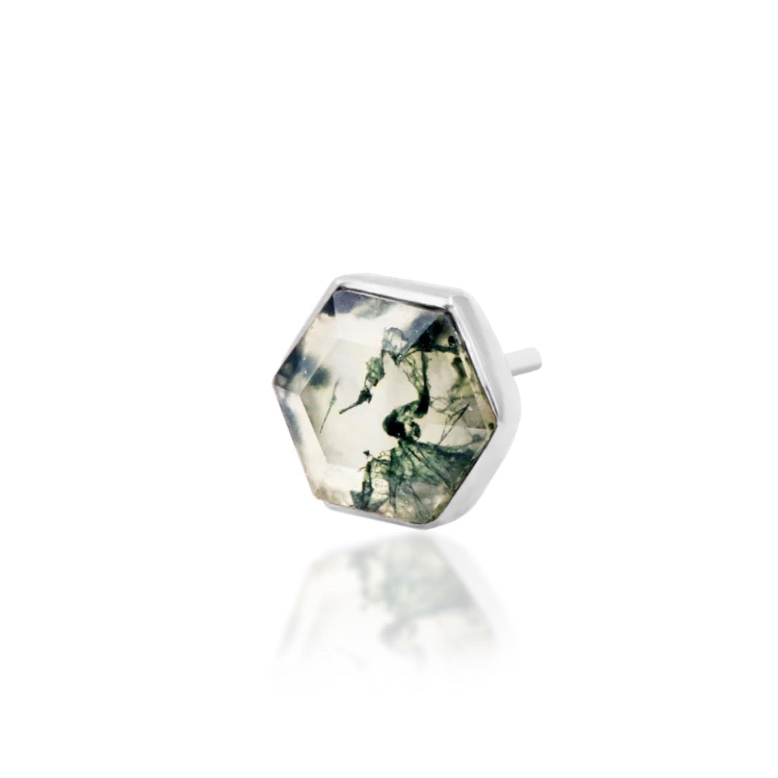 Angled view of white gold conch jewellery with a geometric moss agate centre stone