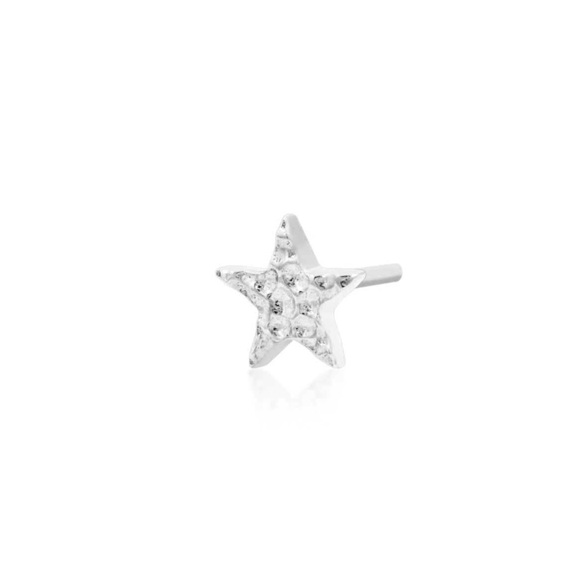 Jewellery for smaller ears in 14k white gold, shown as a petite textured star measuring 4mm across.