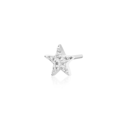 Jewellery for smaller ears in 14k white gold, shown as a petite textured star measuring 4mm across.