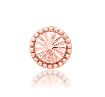 Junipurr Kaya solid 14k gold circular decorative end with a detailed textured surface, product view.