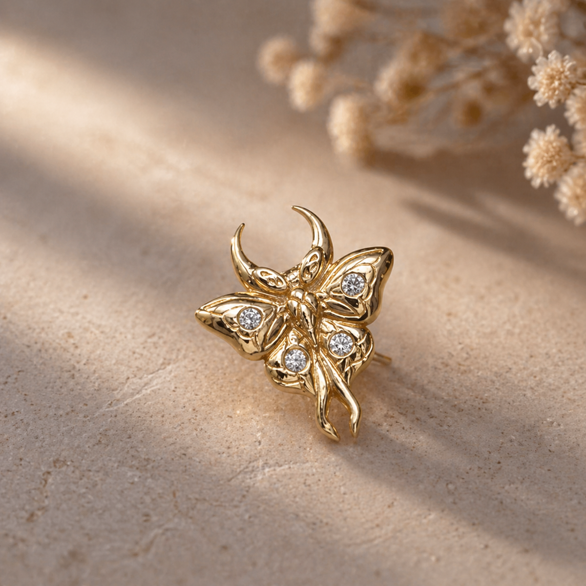 Junipurr Luna solid 14k gold luna moth threadless jewellery with sculpted wing detail.