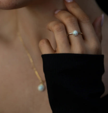 Junipurr Ophelis gold ring with a 5mm synthetic opal and cubic zirconia accents, product view.
