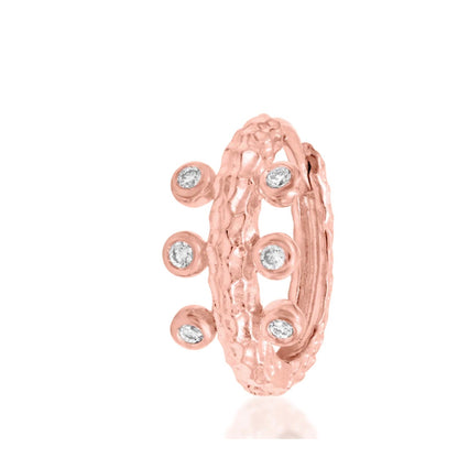 Open rose gold Junipurr Rora clicker showing its sculptural surface texture and six evenly spaced cubic zirconia stones.