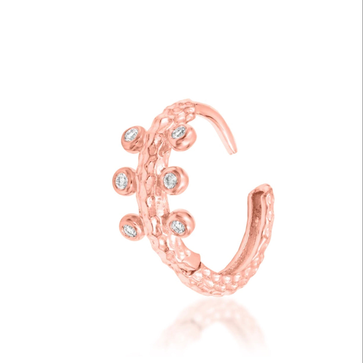 Junipurr Rora textured hoop in solid 14k rose gold with six cubic zirconia stones set around the curved band.