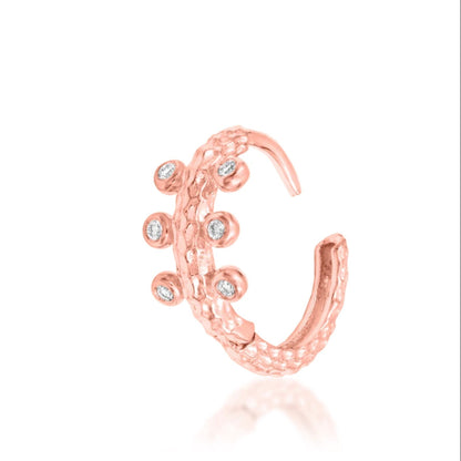 Junipurr Rora textured hoop in solid 14k rose gold with six cubic zirconia stones set around the curved band.