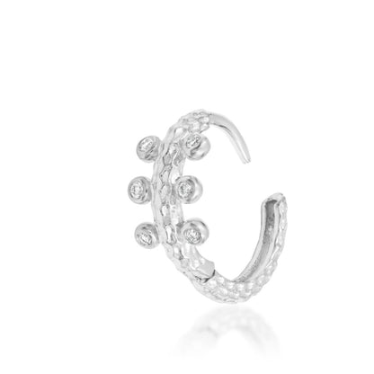 Solid 14k white gold Junipurr Rora ring with a dimensional textured surface and six cubic zirconia stones.