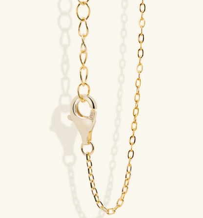 Junipurr Ulan gold pendant necklace with green CZ, product view.