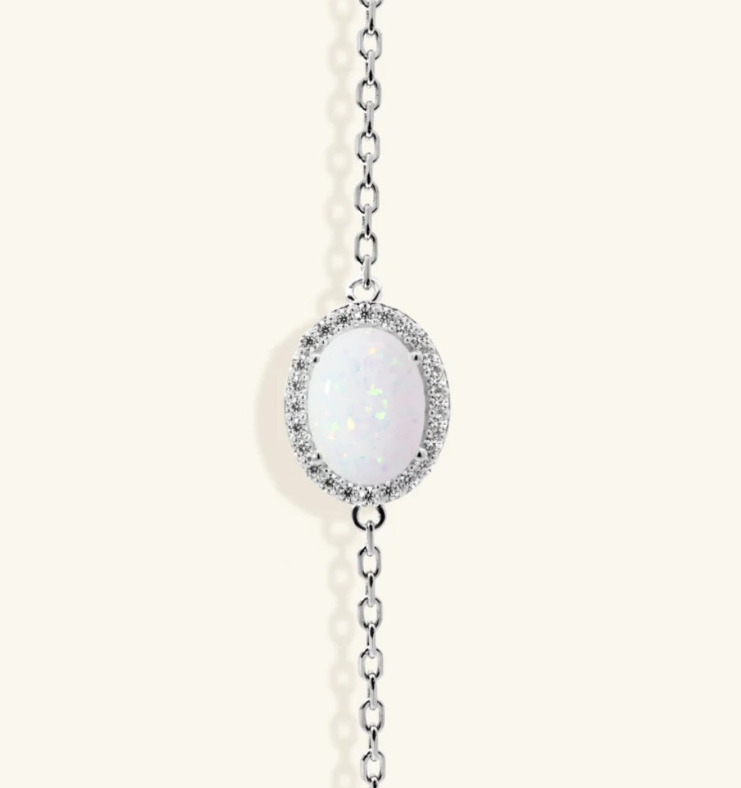 Junipurr Ulora adjustable gold bracelet with a synthetic opal and cubic zirconia halo, product view.