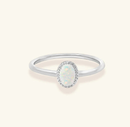 Junipurr Uzara halo ring with opal centre and cubic zirconia accents, product view.
