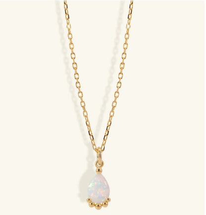 Junipurr Uzira gold necklace with a 6mm × 8mm synthetic opal pendant, product view.
