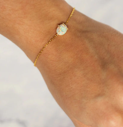Junipurr Vasara gold-vermeil bracelet with a synthetic opal centre and cubic zirconia halo, product view.