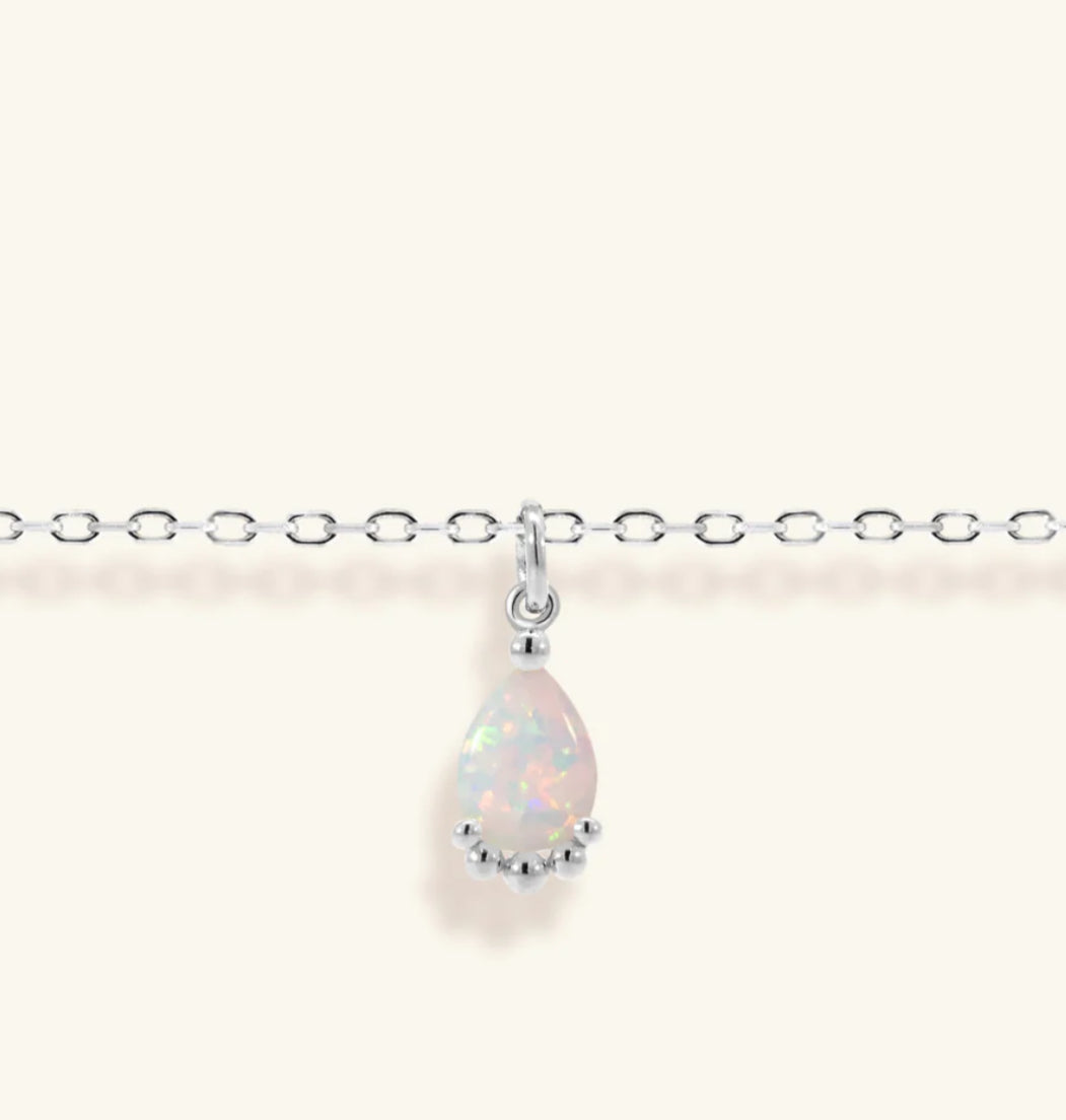 Junipurr Viera adjustable gold bracelet with a 6mm × 8mm synthetic opal, product view.