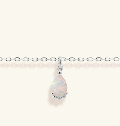 Junipurr Viera adjustable gold bracelet with a 6mm × 8mm synthetic opal, product view.