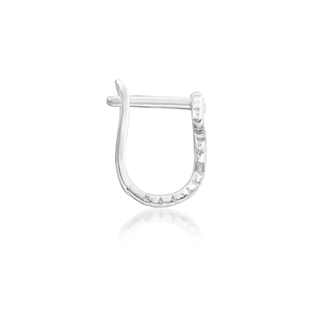 Low-profile nose ring in 14k white gold, shown in Junipurr Dusa’s close-fitting D-shaped design.

